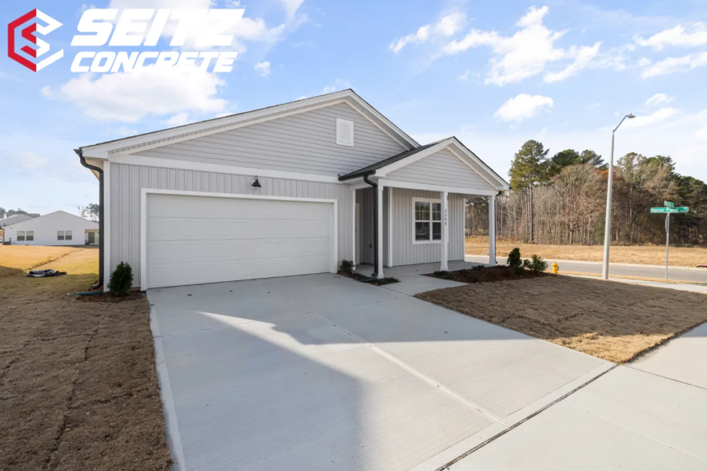 How Much Does a Concrete Driveway Cost 1 a white house with a driveway